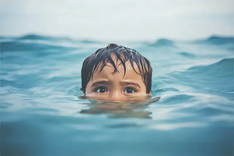 A fearful boy in the water