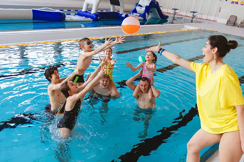 Children playing with a ball in a pool