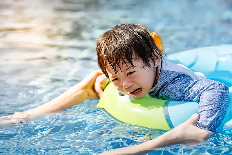 A fearful child in the pool